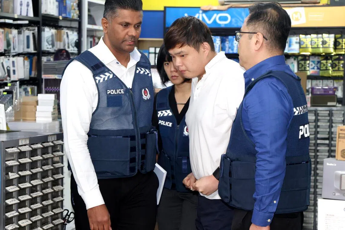 马国籍嫌犯隋明益（29岁）在店里待了几分钟，就被警方押回警车带走。（郑一鸣摄）
