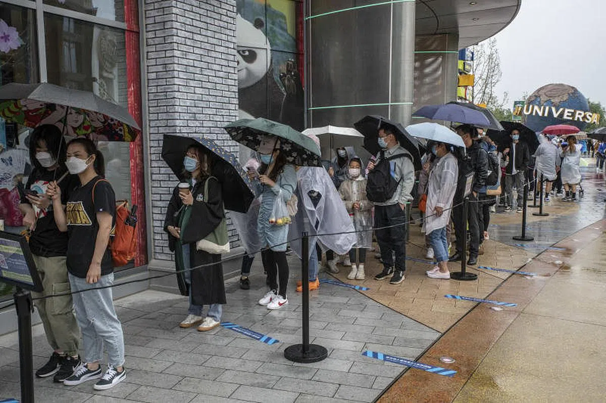 中国不少游客昨日冒雨排队体验刚开幕的北京环球影城。（彭博社）