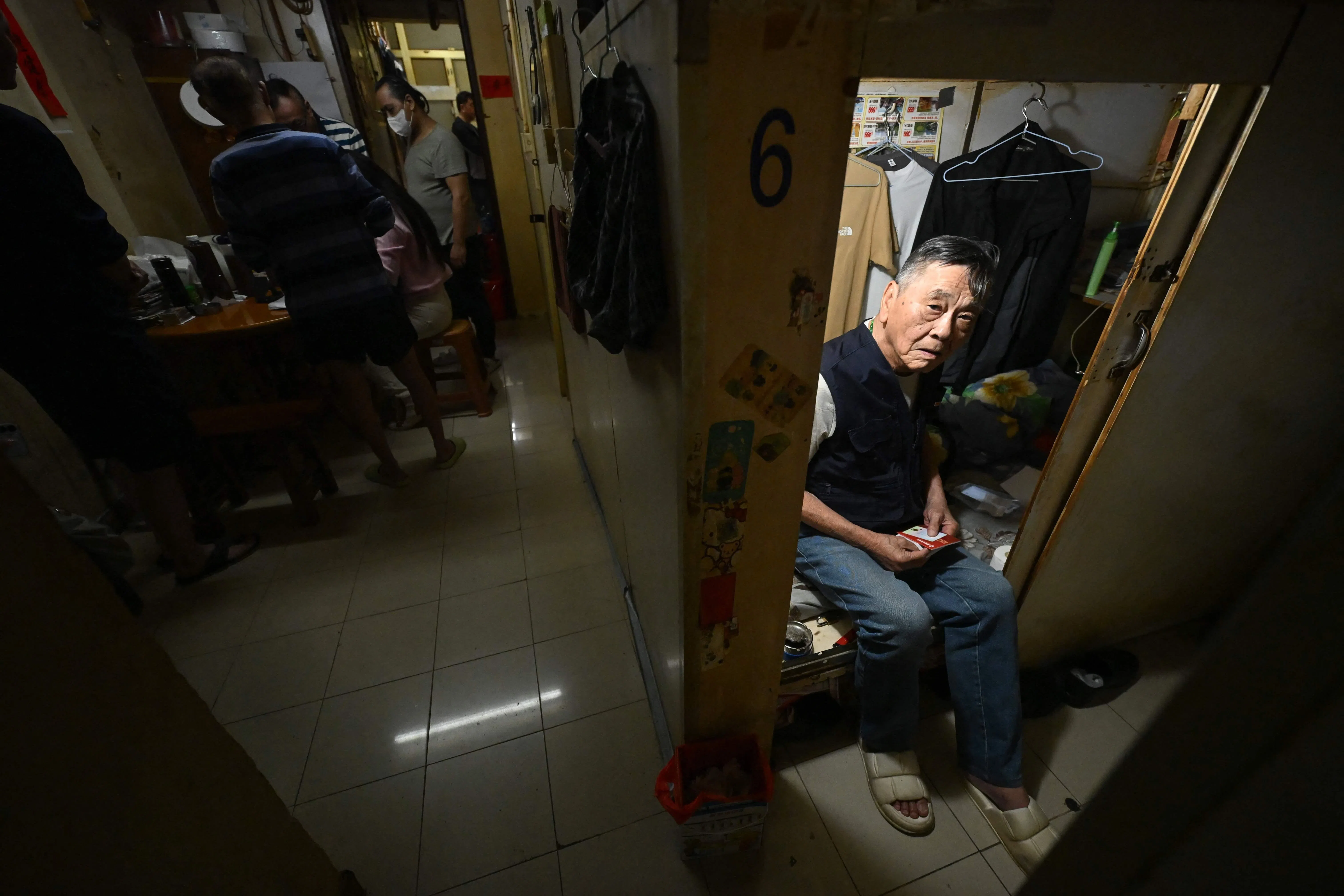 5月4日，一名男子从他位于香港九龙的“笼屋”向外张望。（法新社）
