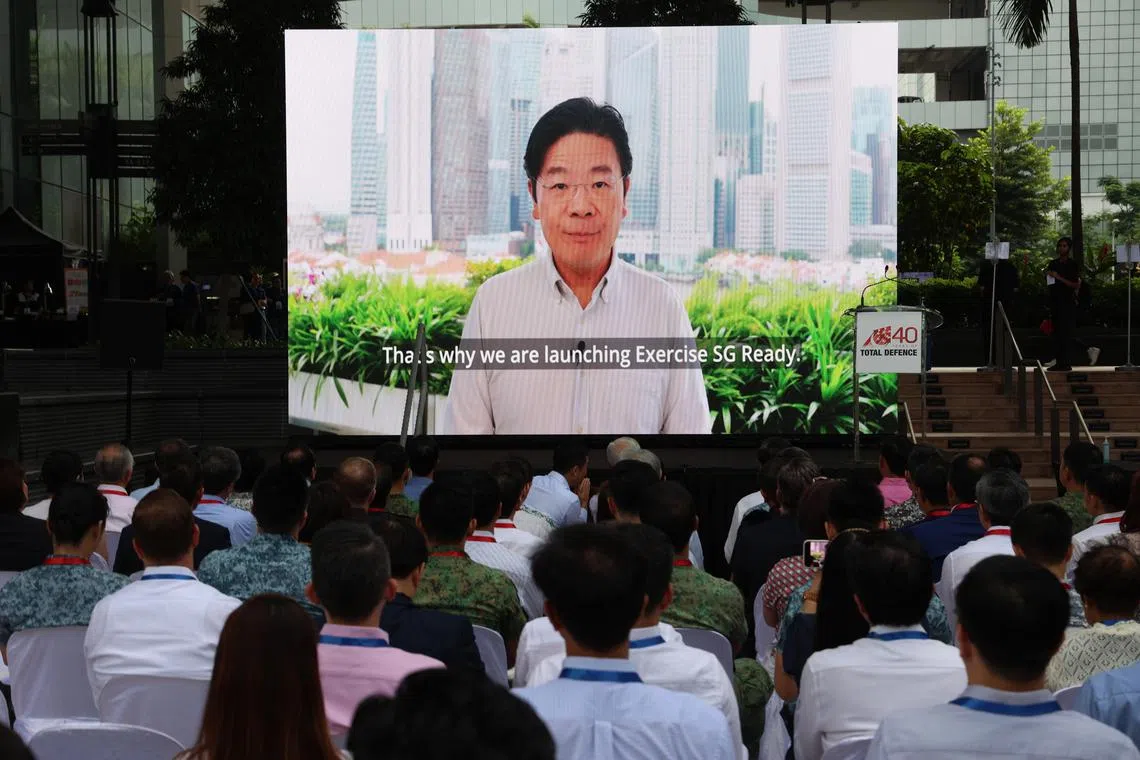副总理兼财政部长黄循财在风华南岸（South Beach Tower）举行的全面防卫日纪念活动上，通过预录视频，正式宣布新加坡齐心应变演习（Exercise SG Ready）启动。（关俊威摄）