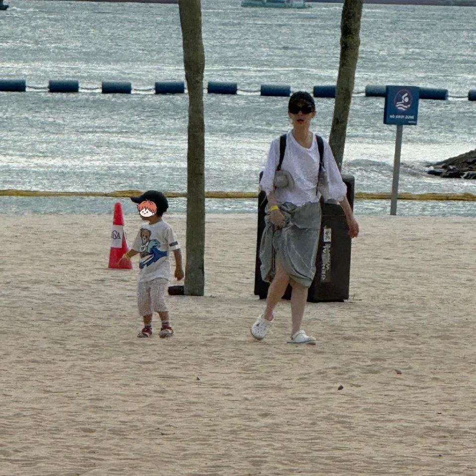 戚薇和李承铉2025年底曾来新旅游，当时有网民拍到戚薇带着儿子在圣淘沙的沙滩上漫步（图）。（互联网）