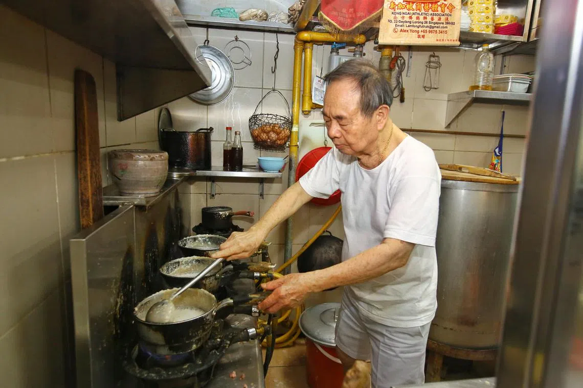 鸿记粥摊主坚持用长木匙搅拌粥四小时，确保煮出广东粥的最佳风味。（特约陈福洲摄）