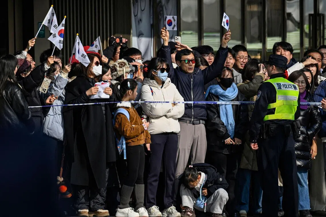 韩国总统李在明星期三（1月7日）参访大韩民国临时政府旧址期间，围观民众在附近挥舞韩国国旗。（法新社）