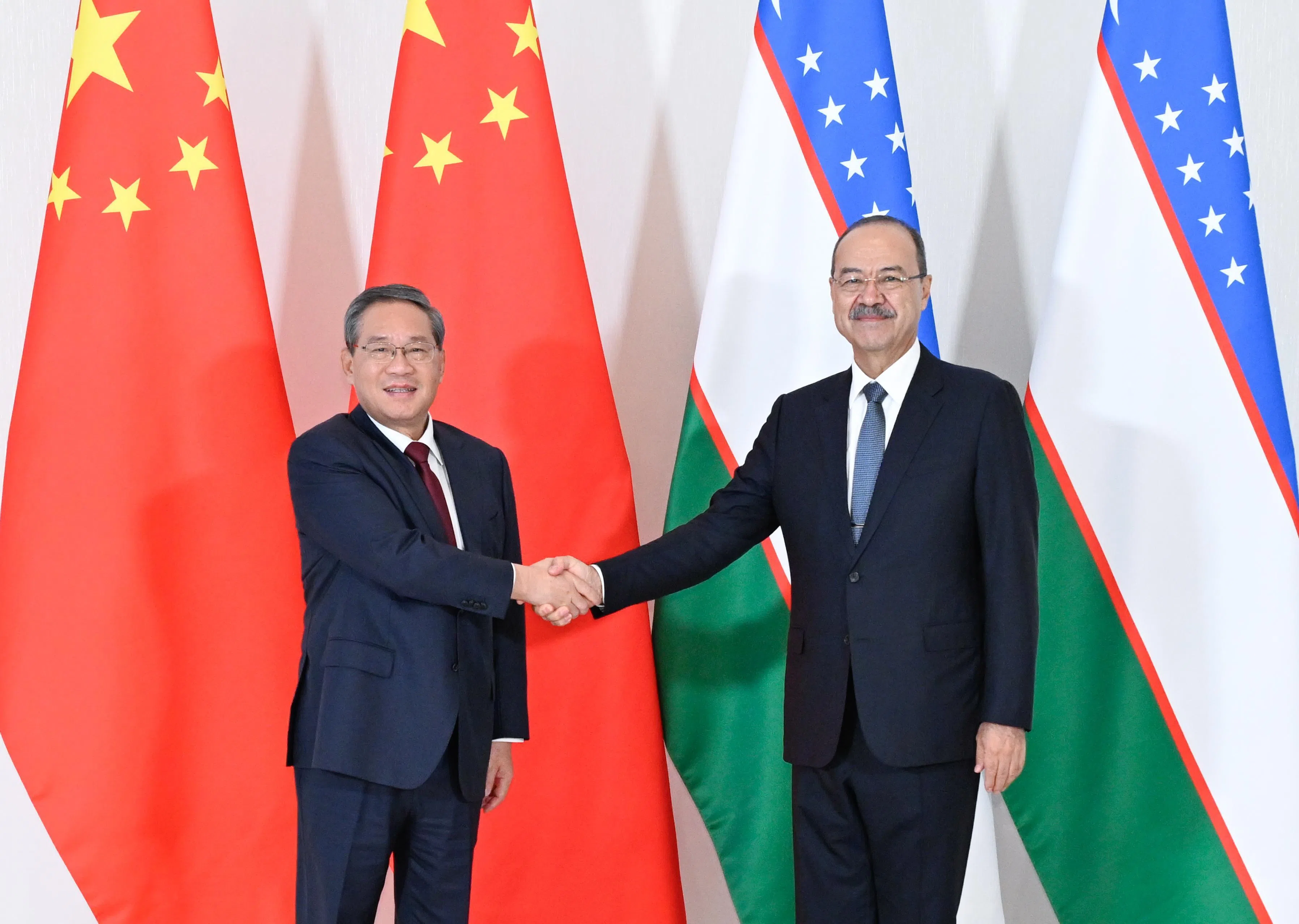中国国务院总理李强（左）上星期六（10月17日）在乌兹别克斯坦首都塔什干与乌总理阿里波夫举行会谈。（新华社）