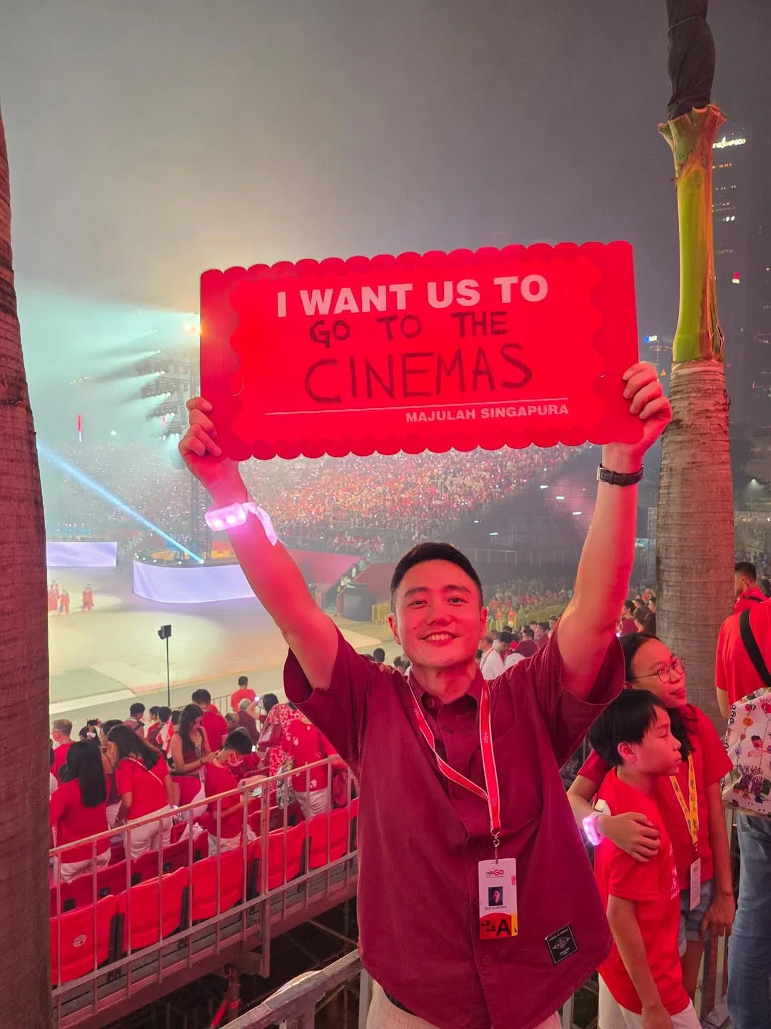 新加坡导演巫俊锋在国庆庆典上，高举写着“我希望我们进戏院”的心愿牌。（取自巫俊锋IG）