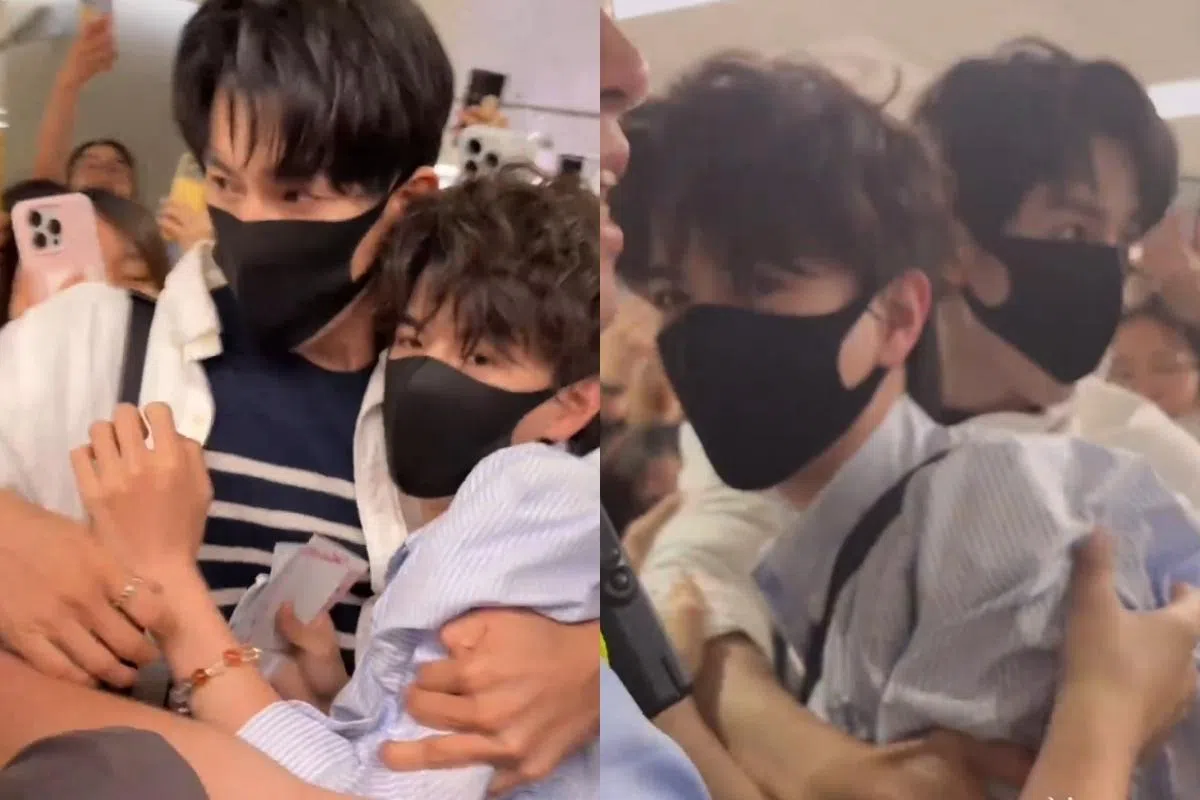 穿着白色衬衫内搭蓝白线条上衣的孙政，以肉身保护穿着浅蓝色衬衫的吕思瞳。（微博视频截图）