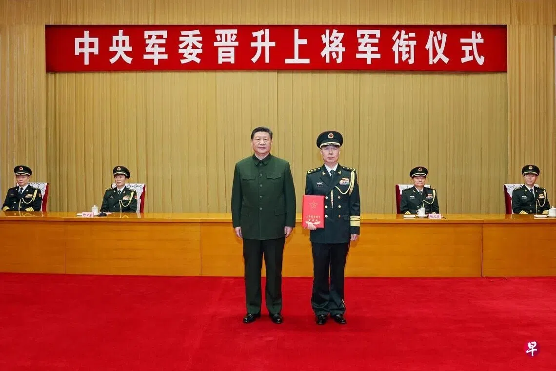 中共中央军委主席习近平（前排左）去年12月23日在北京八一大楼，向获晋升上将军衔的陆军政治委员陈辉（前排右）颁发命令状。（新华社）