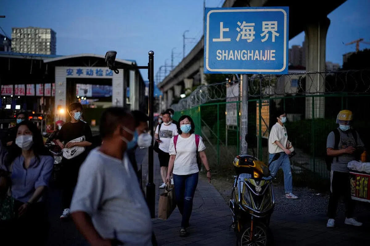 戴着口罩的人群，正越过上海与江苏省的交界处。（路透社）