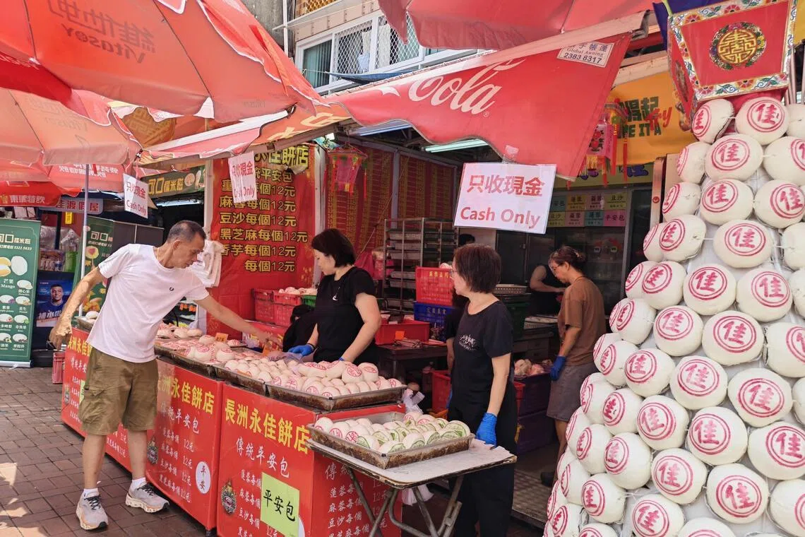 长洲三家饼店一早摆满各式口味平安包，从传统麻蓉到红豆沙、莲蓉和黑芝麻等应有尽有。（陈爱薇摄）